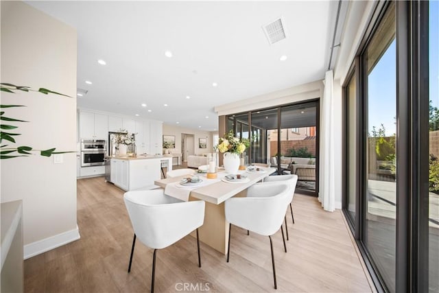 dining area with light wood-type flooring