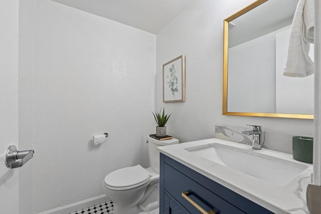 bathroom featuring toilet and vanity