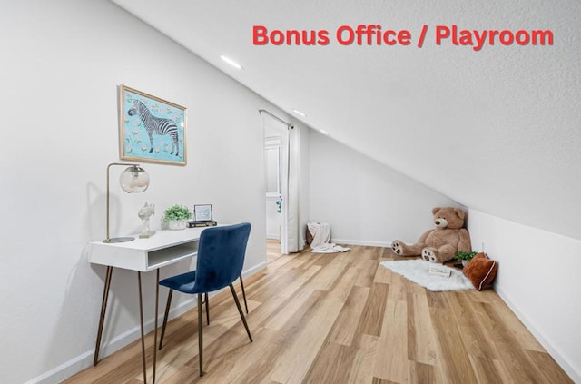 office space featuring lofted ceiling and light wood-type flooring