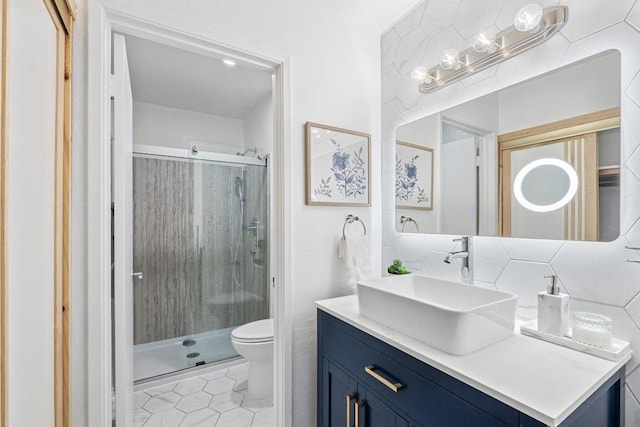 bathroom with toilet, a shower with door, vanity, and tile patterned floors