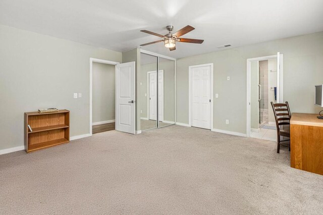 carpeted office with ceiling fan