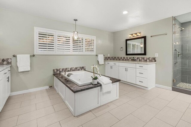 bathroom with vanity, tile patterned flooring, and plus walk in shower