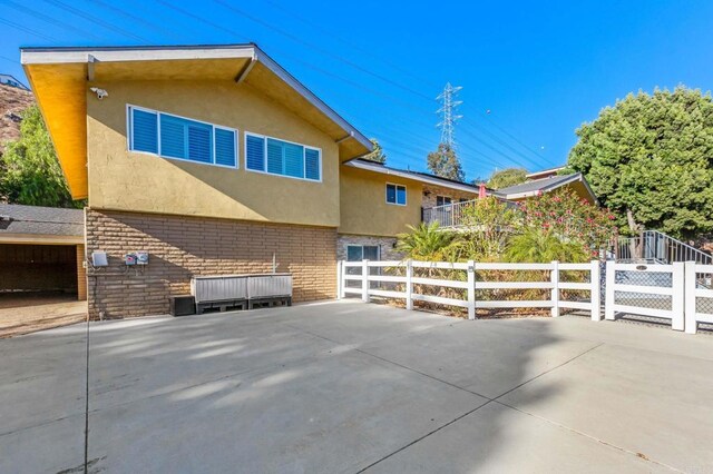 view of side of home with a patio area