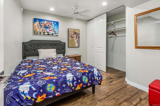 bedroom with ceiling fan, wood-type flooring, and a closet