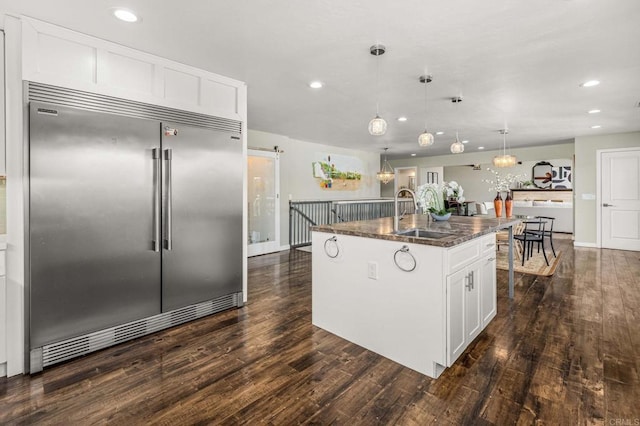 2846 Willow Glen Dr, El Cajon, CA 92019 - kitchen with stainless steel built in refrigerator, a sink, recessed lighting, dark wood-style floors, and dark stone counters