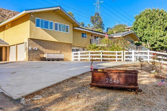 2846 Willow Glen Dr, El Cajon, CA 92019 - view of home's exterior featuring brick siding, stucco siding, driveway, and an attached garage