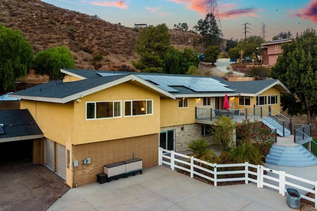 2846 Willow Glen Dr, El Cajon, CA 92019 - view of front of home featuring stairway, stucco siding, solar panels, a garage, and stone siding