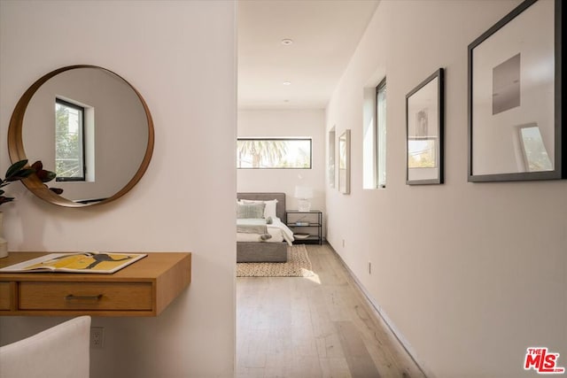 corridor with light hardwood / wood-style floors