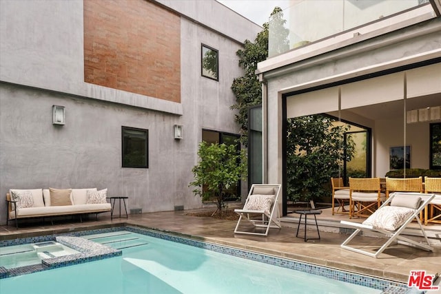 exterior space featuring a patio area and an in ground hot tub