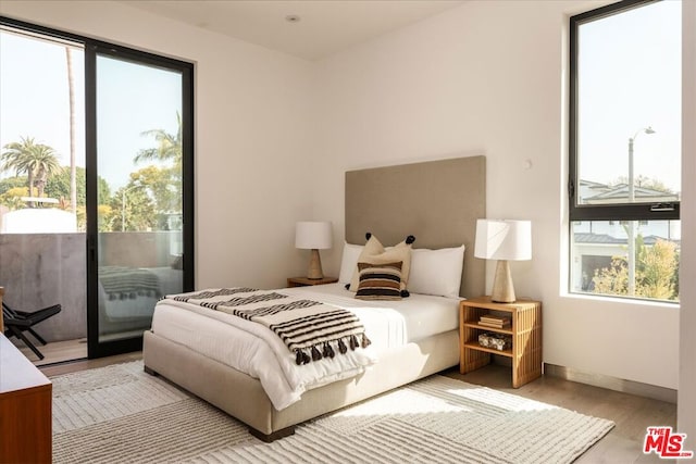 bedroom featuring light hardwood / wood-style flooring and access to outside