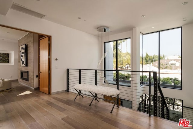 sitting room with wood-type flooring and a fireplace