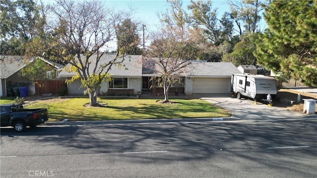 ranch-style home featuring a garage and a front yard