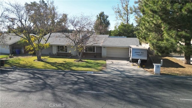 single story home featuring a garage and a front yard