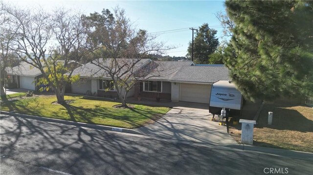 ranch-style house featuring a front yard and a garage