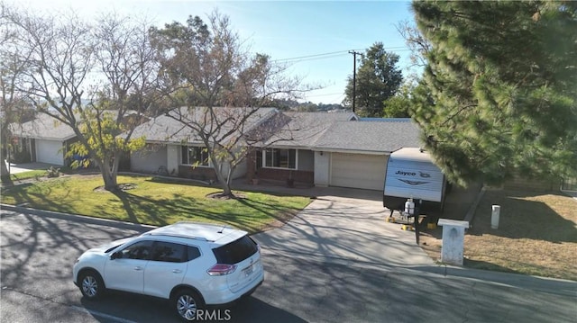 single story home featuring a garage and a front lawn