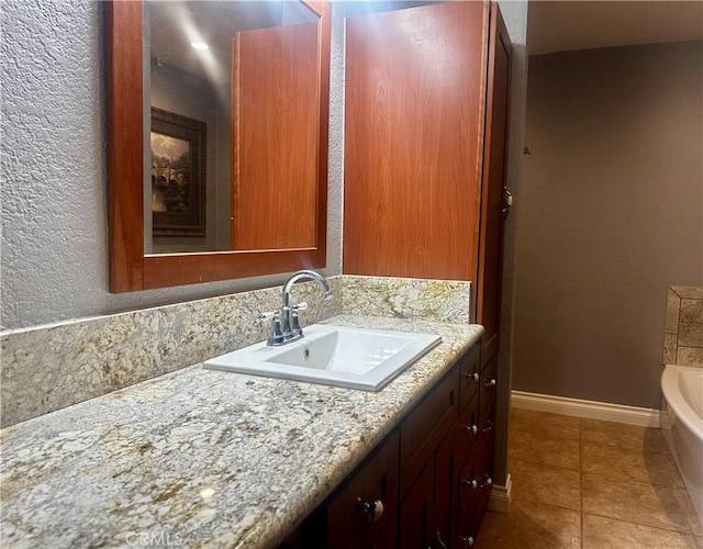 bathroom featuring vanity, tile patterned floors, and a bathtub