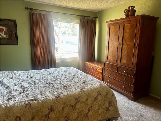 bedroom featuring light carpet and a textured ceiling