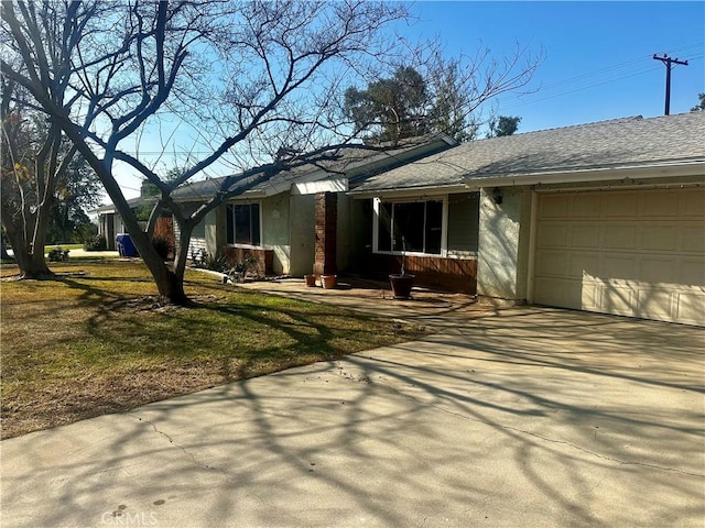 view of property exterior featuring a garage and a lawn