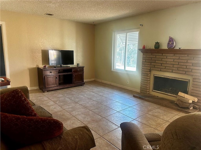 tiled living room featuring a textured ceiling and a fireplace