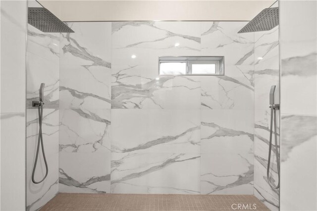 full bathroom featuring a marble finish shower