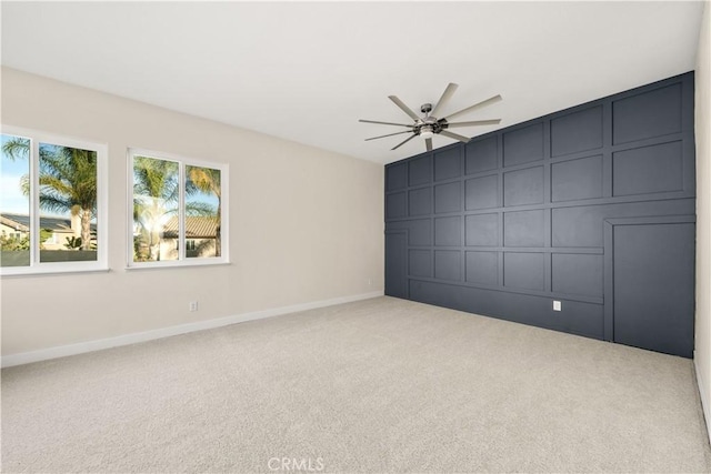 carpeted spare room with ceiling fan