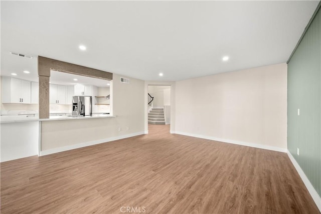 unfurnished living room with light wood-type flooring