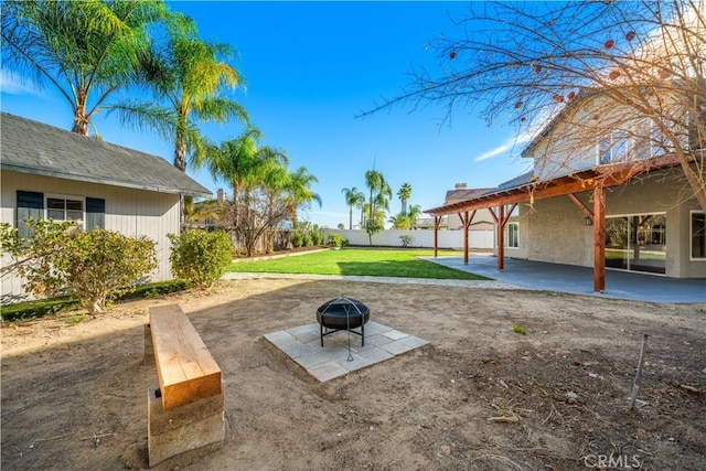 view of yard with an outdoor fire pit and a patio