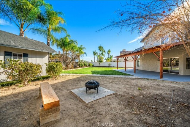 view of yard with a fire pit and a patio