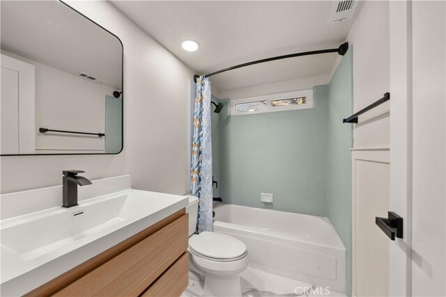 full bathroom featuring toilet, vanity, and shower / tub combo