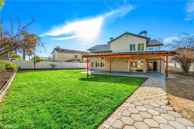 back of property featuring a lawn and a patio