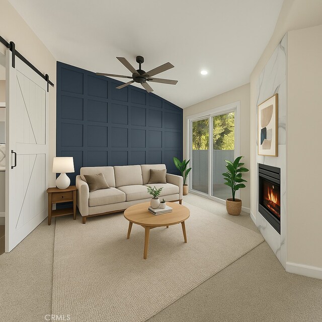 carpeted living area with a decorative wall, a ceiling fan, a barn door, lofted ceiling, and a fireplace