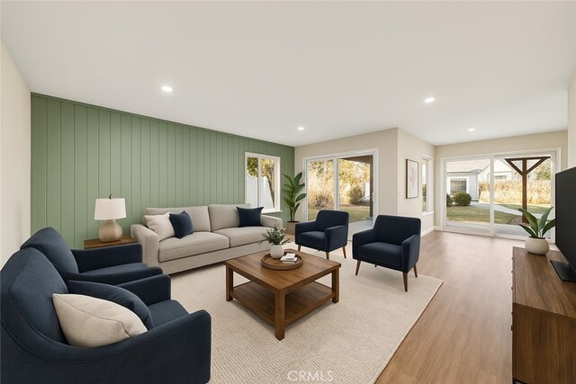 living area with wood finished floors, recessed lighting, and baseboards