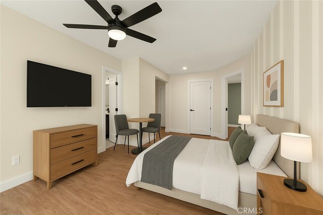 bedroom with baseboards, light wood finished floors, and a ceiling fan