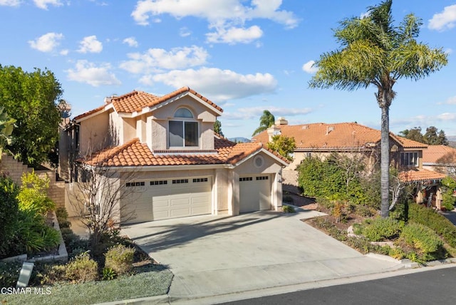 mediterranean / spanish house with a garage