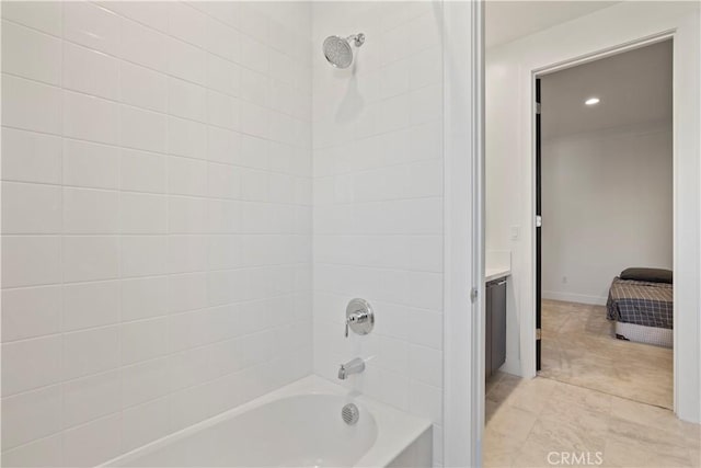 bathroom featuring vanity and tiled shower / bath