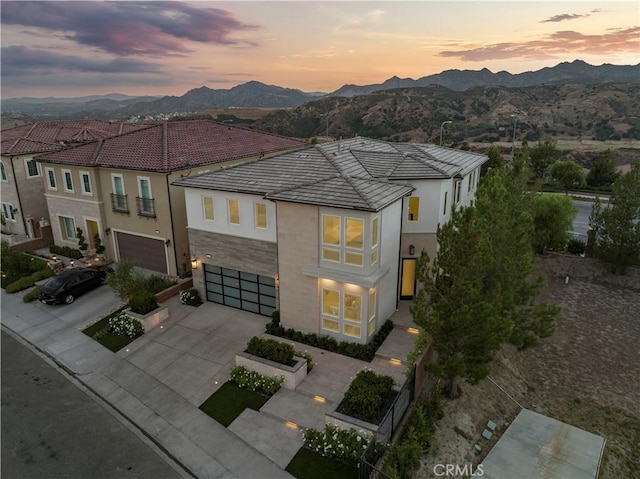 view of front of house featuring a garage and a mountain view