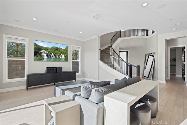 living room with light hardwood / wood-style floors and ornamental molding