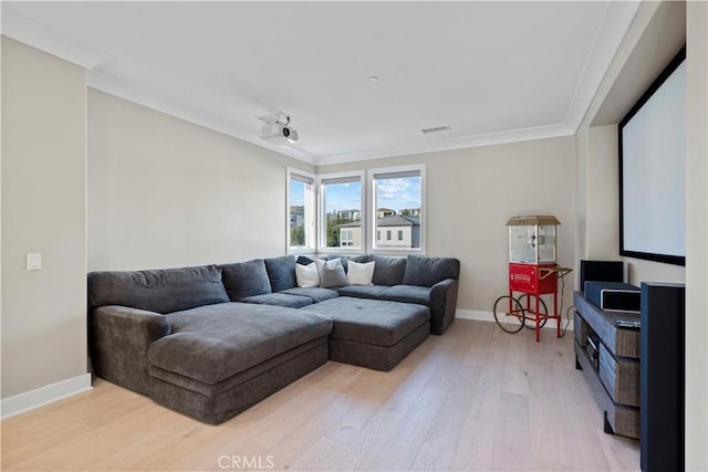 living room featuring crown molding and light hardwood / wood-style floors