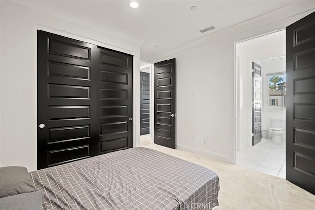 bedroom featuring carpet flooring, crown molding, and connected bathroom