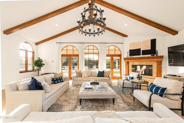 living room featuring a notable chandelier, beamed ceiling, plenty of natural light, high vaulted ceiling, and french doors