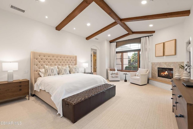 bedroom with a fireplace, light carpet, and vaulted ceiling with beams