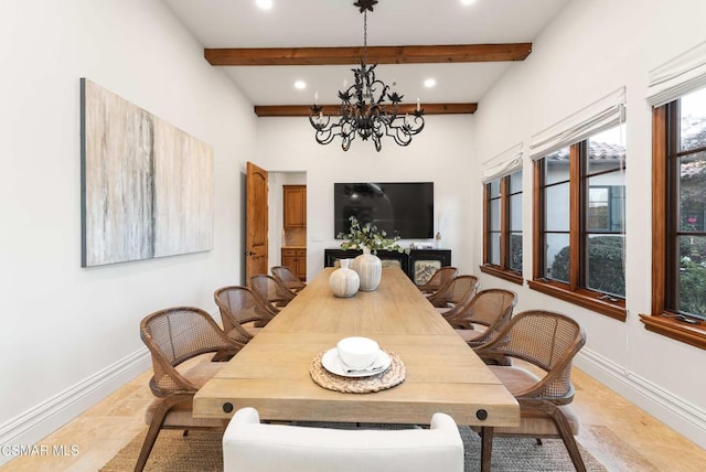 dining area featuring a notable chandelier and beamed ceiling