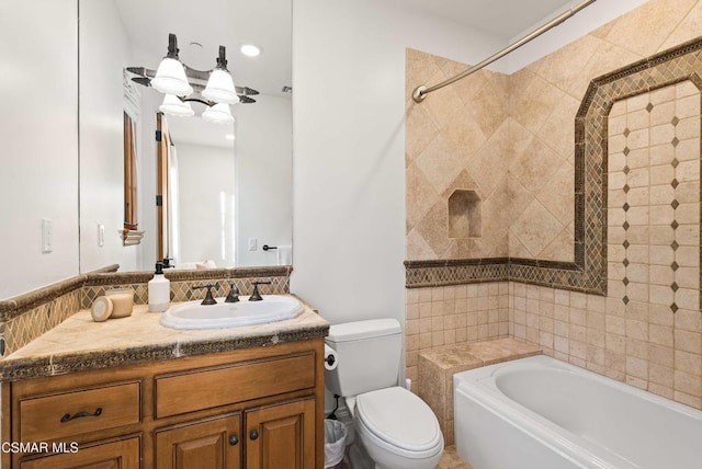 full bathroom with toilet, vanity, and tiled shower / bath combo