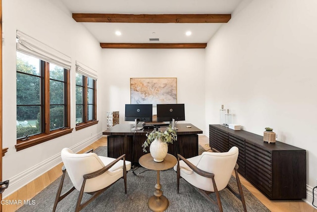 office area with light hardwood / wood-style floors and beamed ceiling