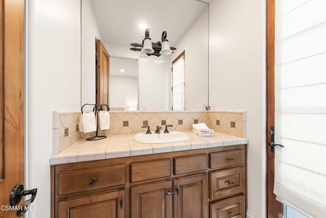 bathroom featuring tasteful backsplash and vanity