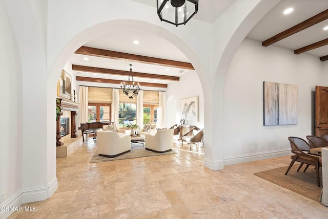 living room with beam ceiling and a notable chandelier