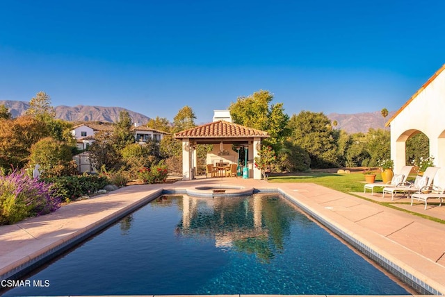 view of swimming pool featuring a mountain view, a gazebo, an in ground hot tub, and a patio