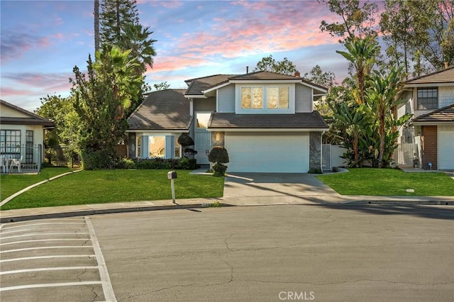 view of front facade with a yard and a garage