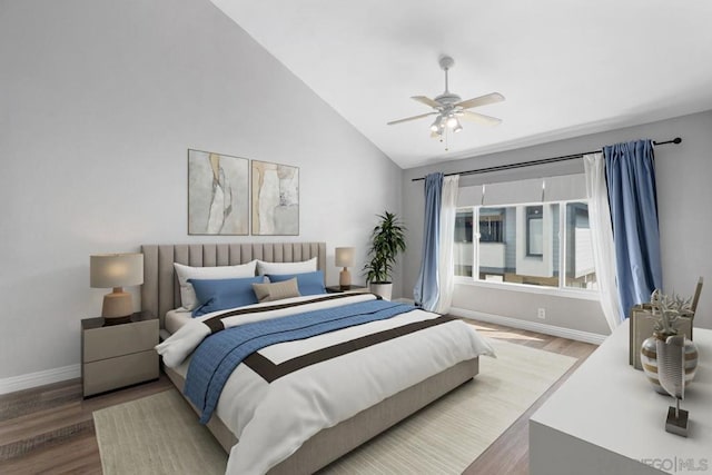 bedroom featuring ceiling fan, lofted ceiling, and hardwood / wood-style floors