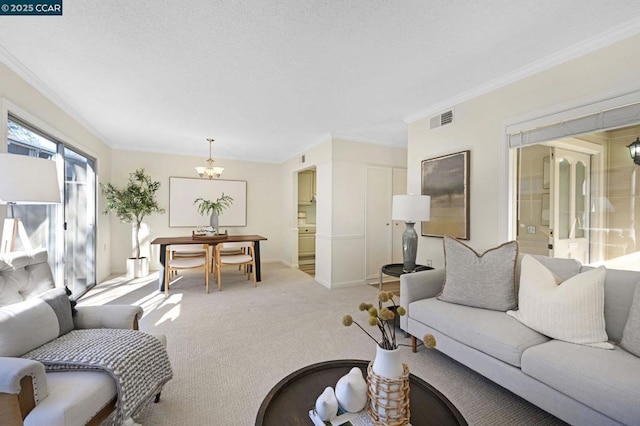 living room with ornamental molding, light carpet, and a notable chandelier